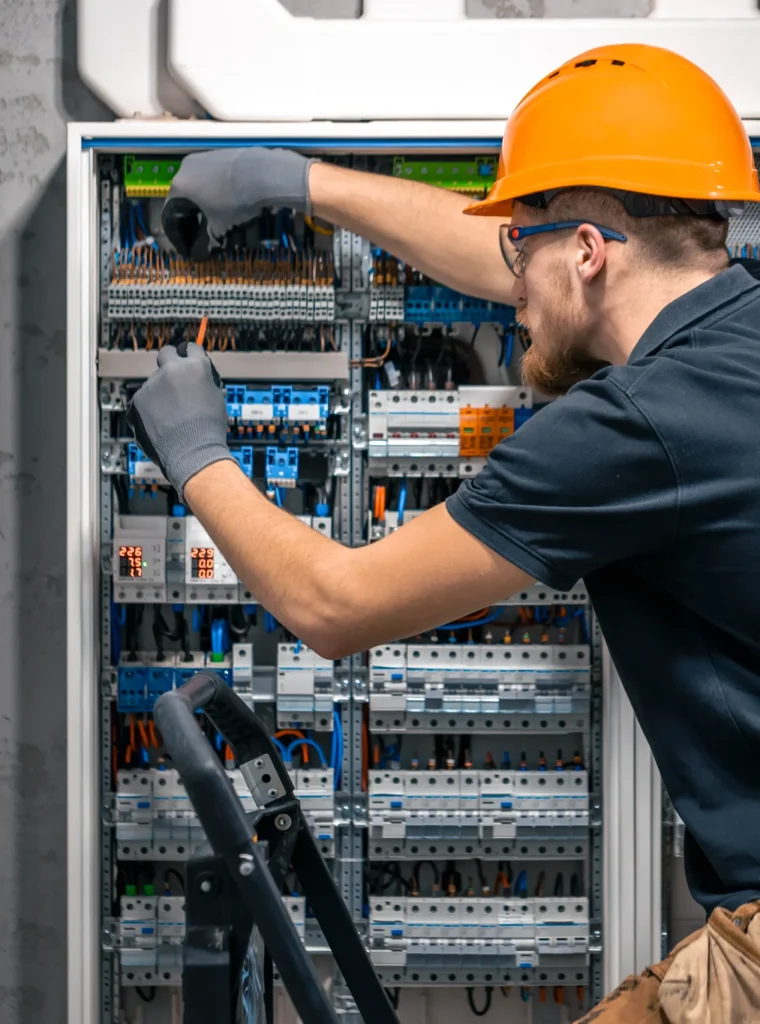male electrician working on switchboard